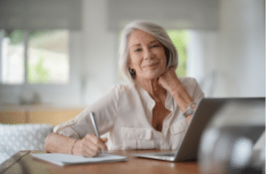 Elderly woman working on computer at home