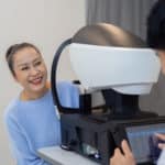 Asian senior woman examining eyesight